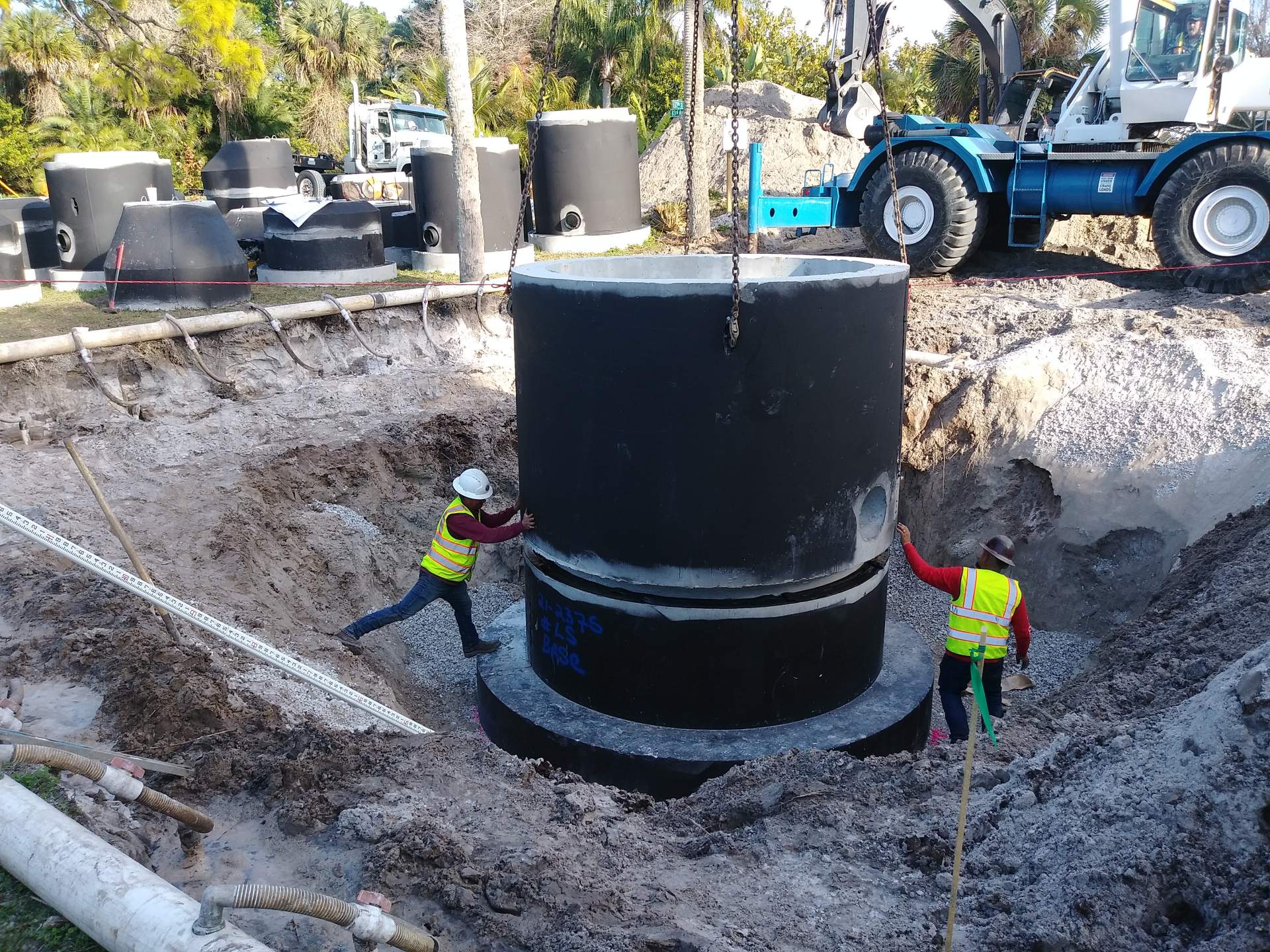 Large machinery in a deep dirt hole on construction site